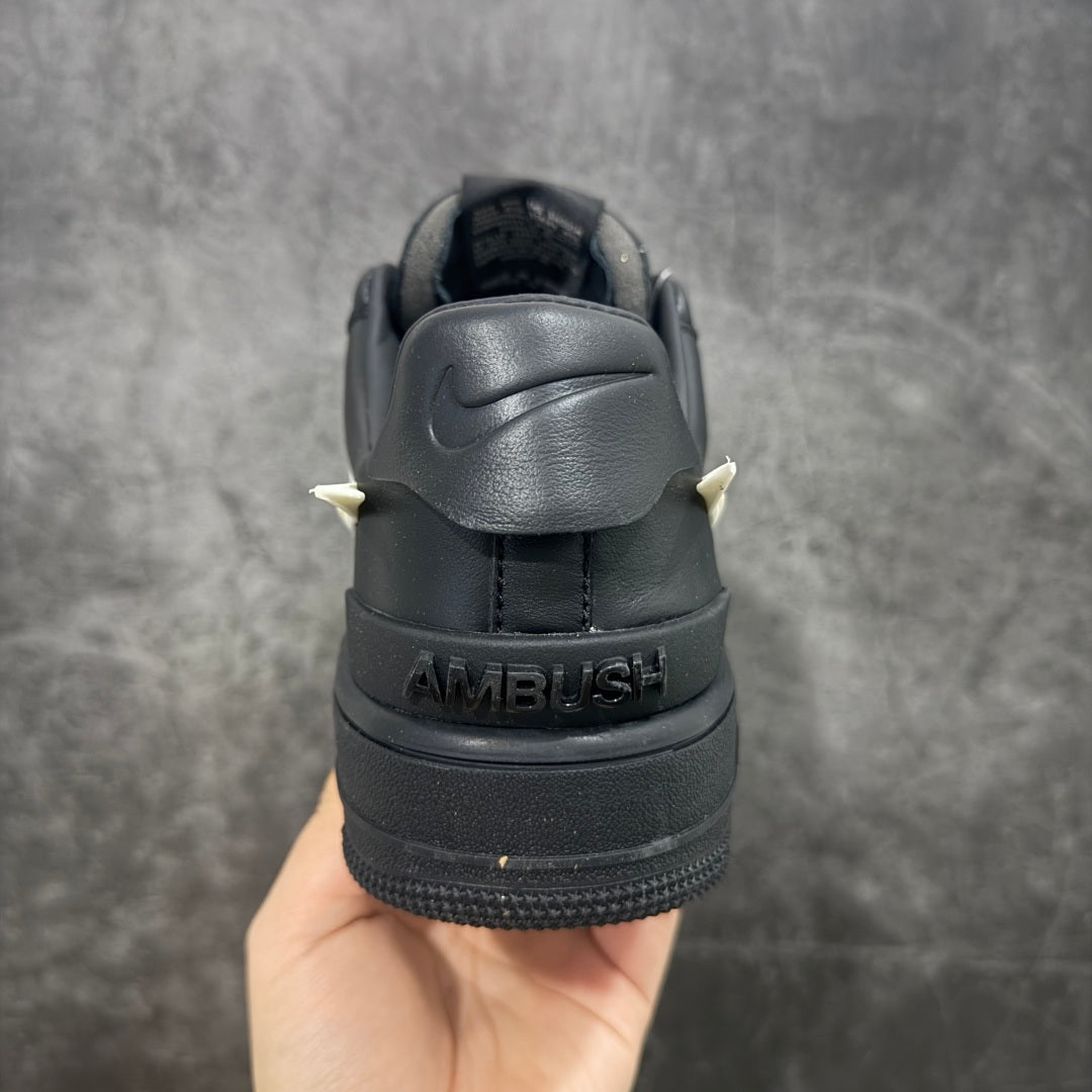 Black sneaker heel with AMBUSH text and Nike logo on the back tab