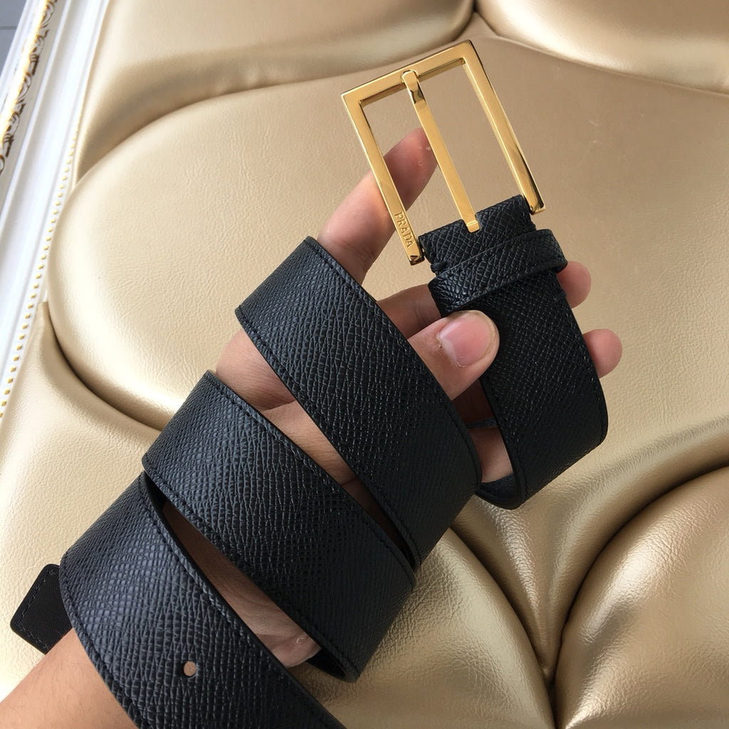 Dark leather belt with gold-tone buckle, multiple strap holes, and stitched edge