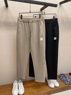 Pair of drawstring sweatpants: beige and black with elastic waistbands