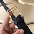 Dark leather belt close-up: gold buckle frame with prong and hand holding