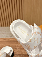 Louis Vuitton slide sandal with white monogram strap and cushioned white footbed