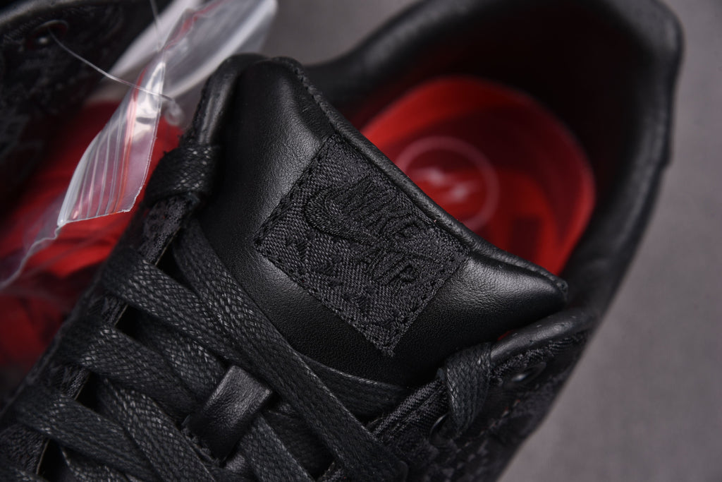 Black sneaker with laced upper and stitched strap detail
