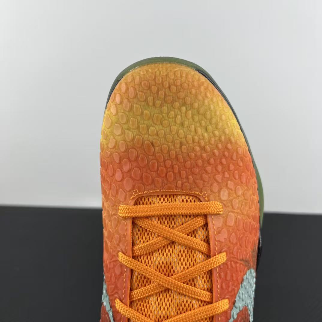 Orange basketball shoe toe with orange laces and textured outsole tread