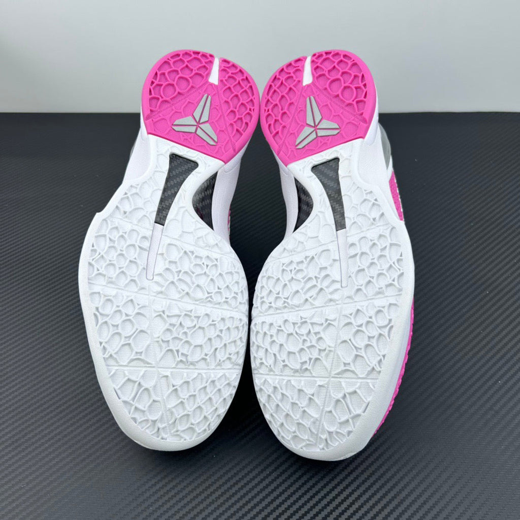 White outsole bottoms with textured traction and pink toe and heel sections