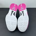 White outsole bottoms with textured traction and pink toe and heel sections