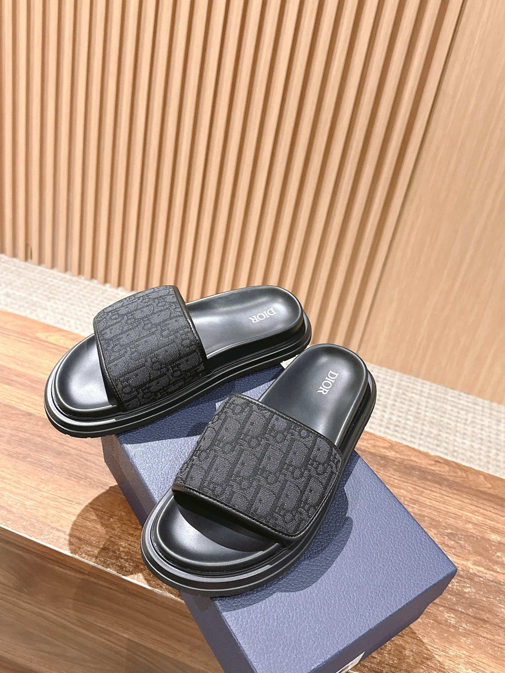 Dior slide sandals with logo-pattern strap and black ridged rubber sole