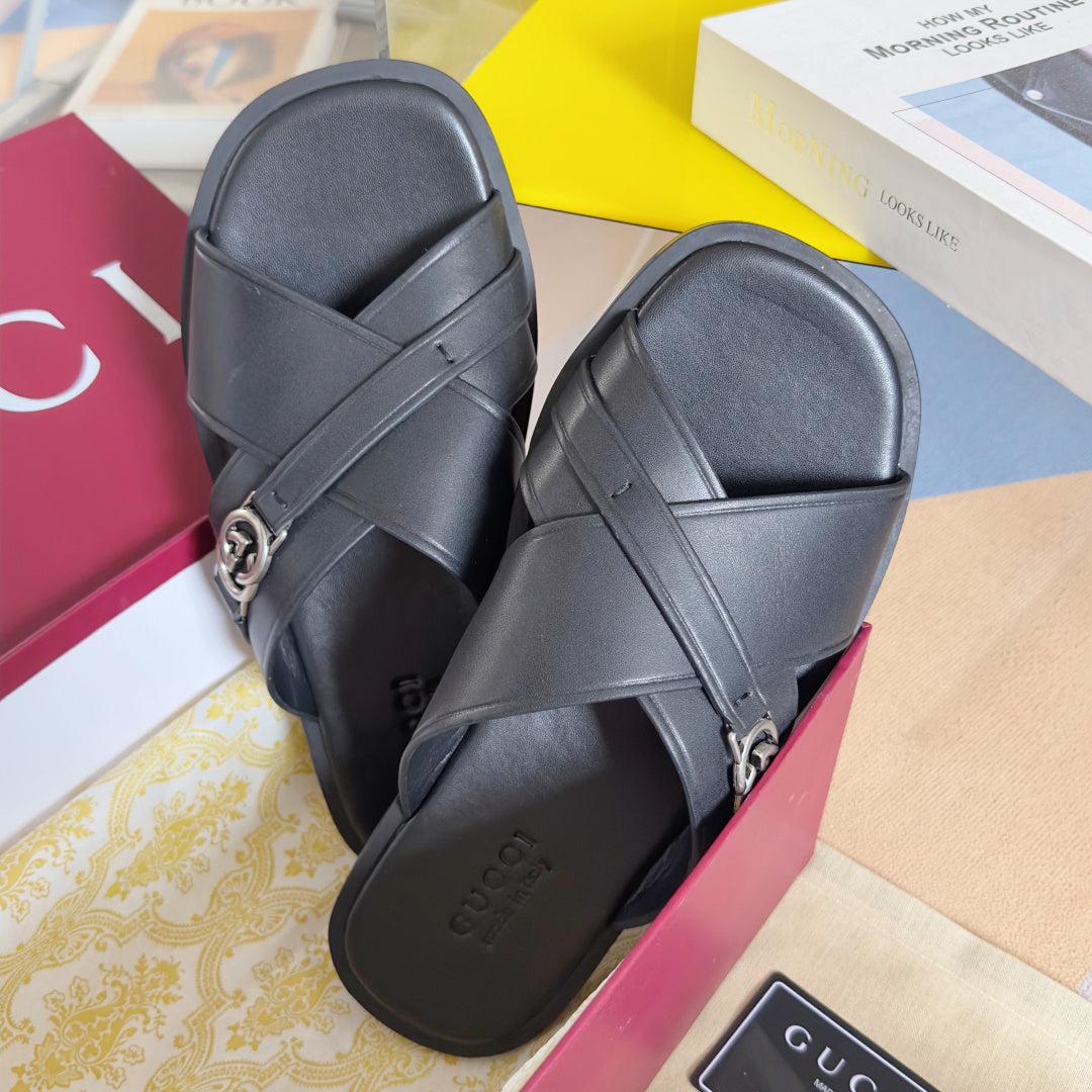 Gucci black leather slide sandals with crossover straps and silver G buckle, top view