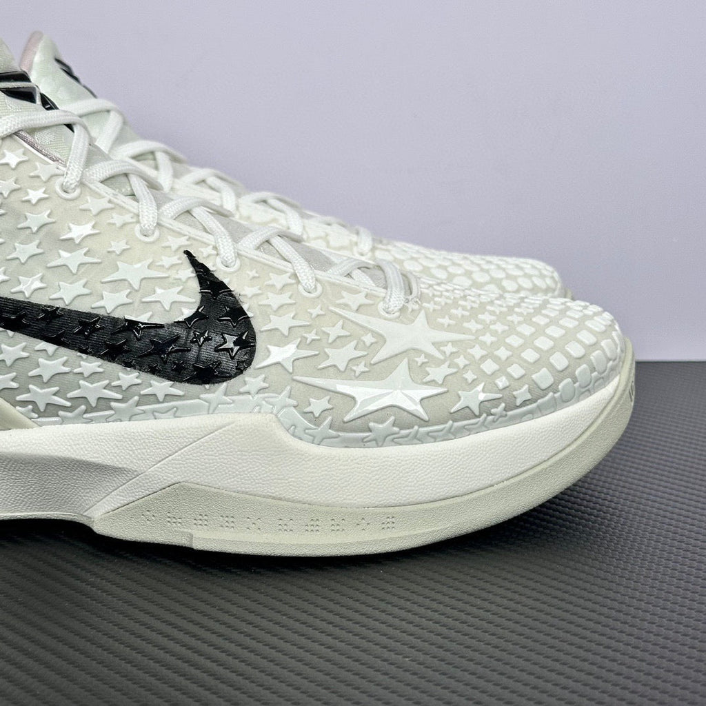 Low-top basketball sneakers side view, white star pattern, black swoosh, white midsole