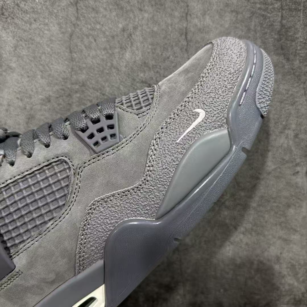 Gray suede sneaker profile with Swoosh mark and translucent side wing detail