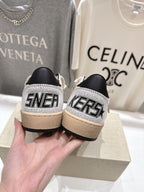 Golden Goose sneakers, view of back with black heel, textured white patch, tan sole
