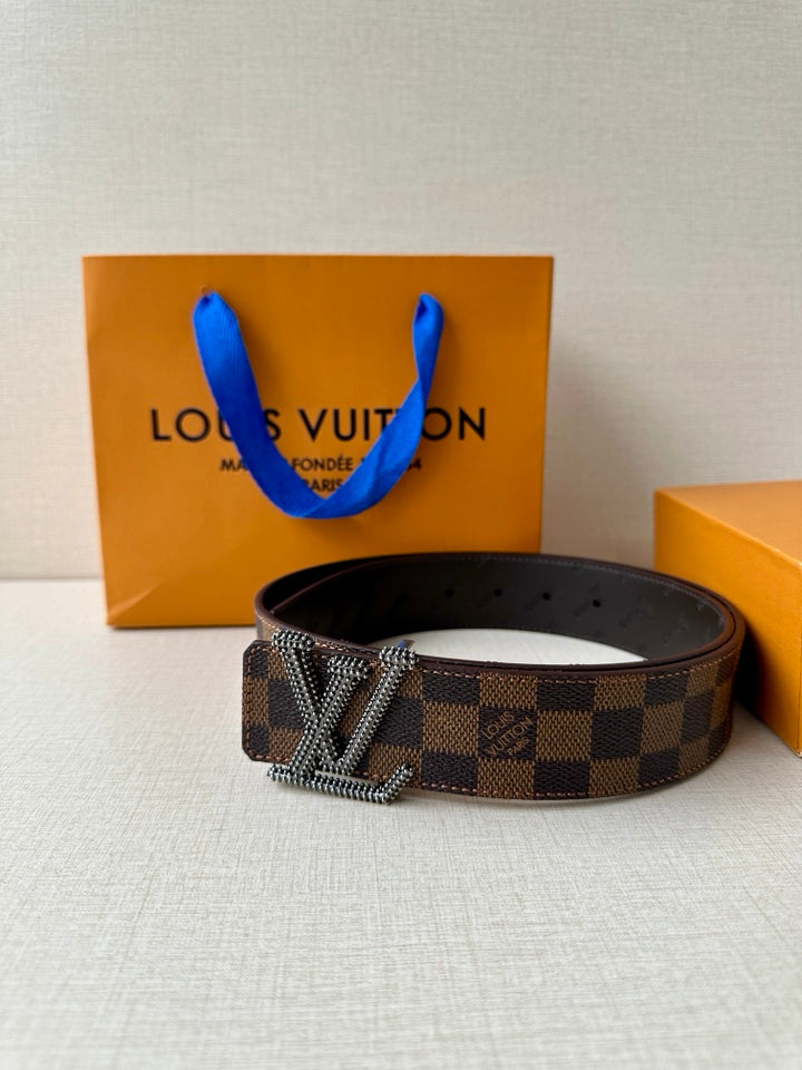 Louis Vuitton belt flat lay with checkered strap and silver V buckle