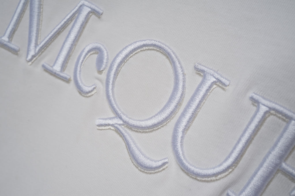 White short-sleeve T-shirt close-up of McQUEEN logo print