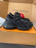 Black lace-up sneakers with rugged sole and red LV heart logo accents
