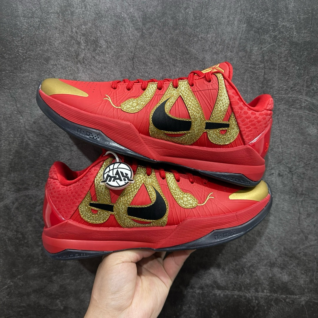 Red basketball shoe with gold graphics, black accents, lace-up design
