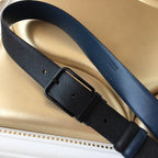 Navy Prada belt on display with rectangular buckle and textured keeper section.