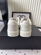 White leather sneakers, rear view with cushioned collar and stitching