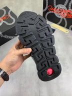 Versace luxury sneaker outsole, black rubber tread with geometric pattern