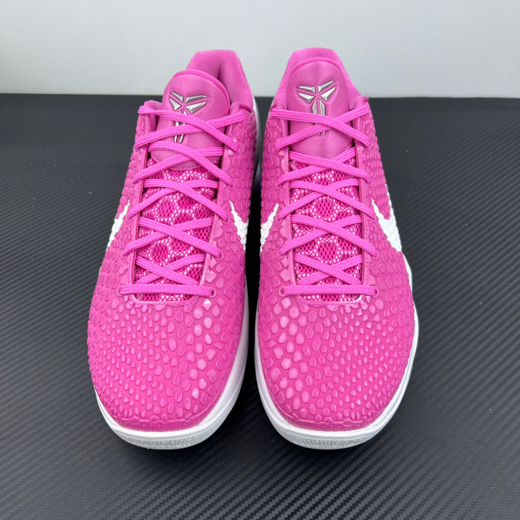 Pair of pink low-top sneakers with lace-up front and white midsole accents