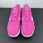 Pair of pink low-top sneakers with lace-up front and white midsole accents
