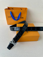 Dark blue croc leather belt with gold-tone LV buckle, laid diagonally
