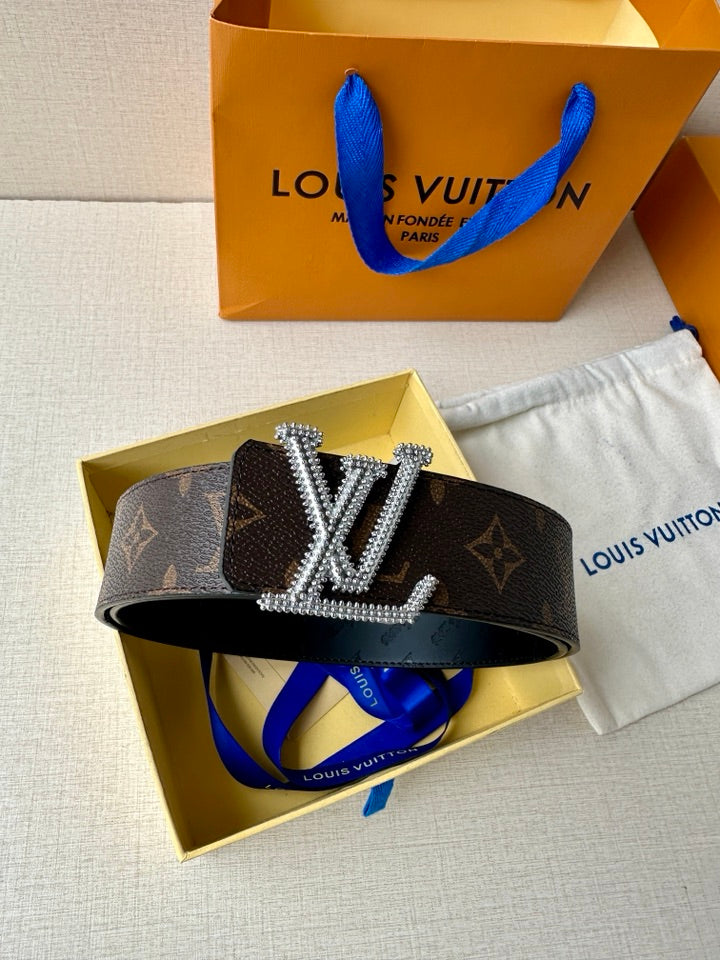 Dark monogram belt with oversized gold LV-style buckle and studded trim
