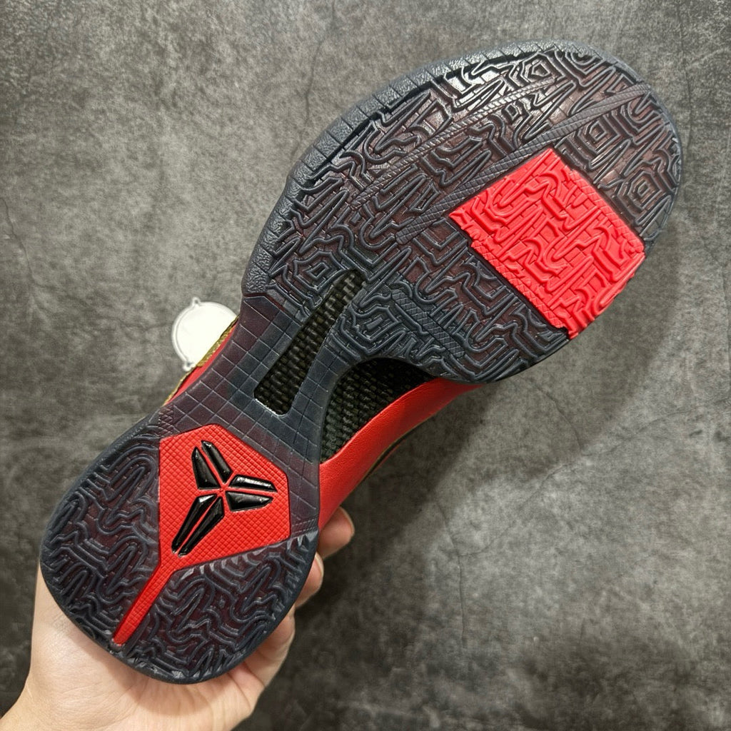 Red and black basketball shoe outsole with patterned traction and herringbone texture