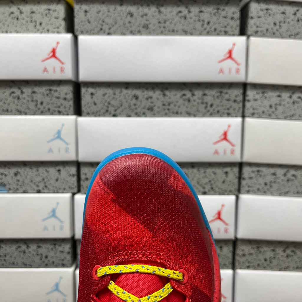 Red heel area with yellow lace eyelets and blue interior lining.