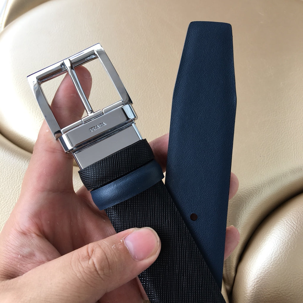 Prada belt with dark textured strap and silver buckle, plus tapered leather end