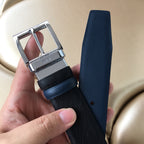 Prada belt with dark textured strap and silver buckle, plus tapered leather end