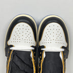 High-top sneaker toe view: white perforated toe box, black panels, white laces, cream trim