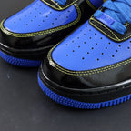 Nike Air Force 1 low-top sneakers; blue perforated toe, black panels, yellow stitching.