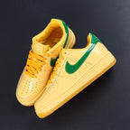 Nike Air Force 1 sneakers, yellow with green swoosh, lace-up pair angle view