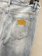 Maison Margiela denim jeans back pocket close-up with yellow rectangular logo label