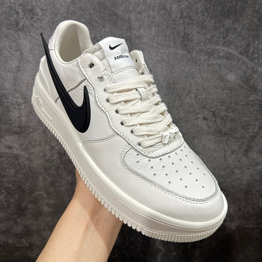 White leather low-top sneaker with black swoosh and lace-up front