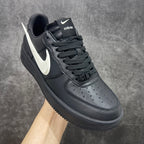 Black leather low-top sneakers with white Nike swoosh and AMBUSH label on tongue