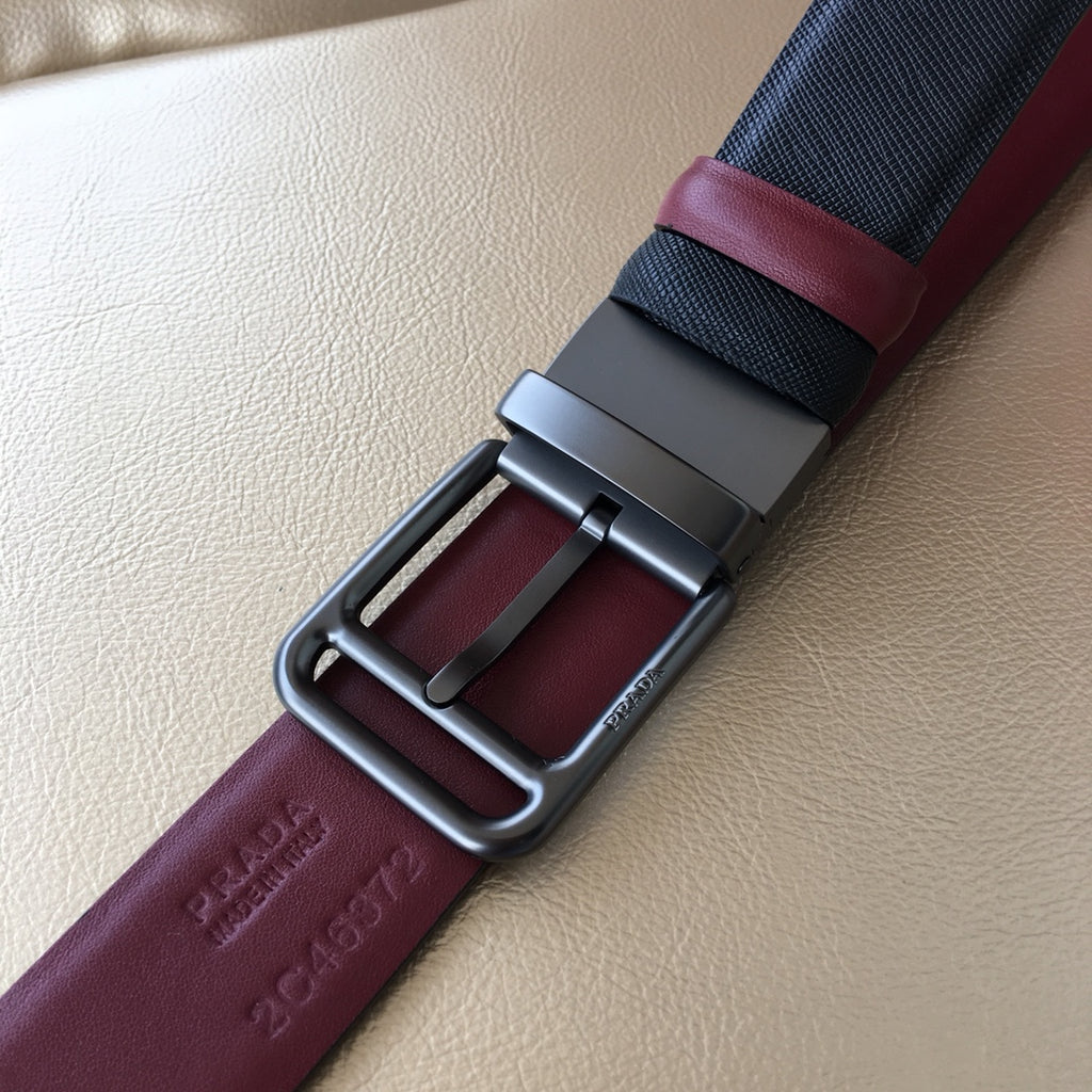Prada belt close-up: dark blue webbing with burgundy leather and silver-tone buckle frame