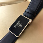 Black textured leather belt with large silver-tone buckle detail