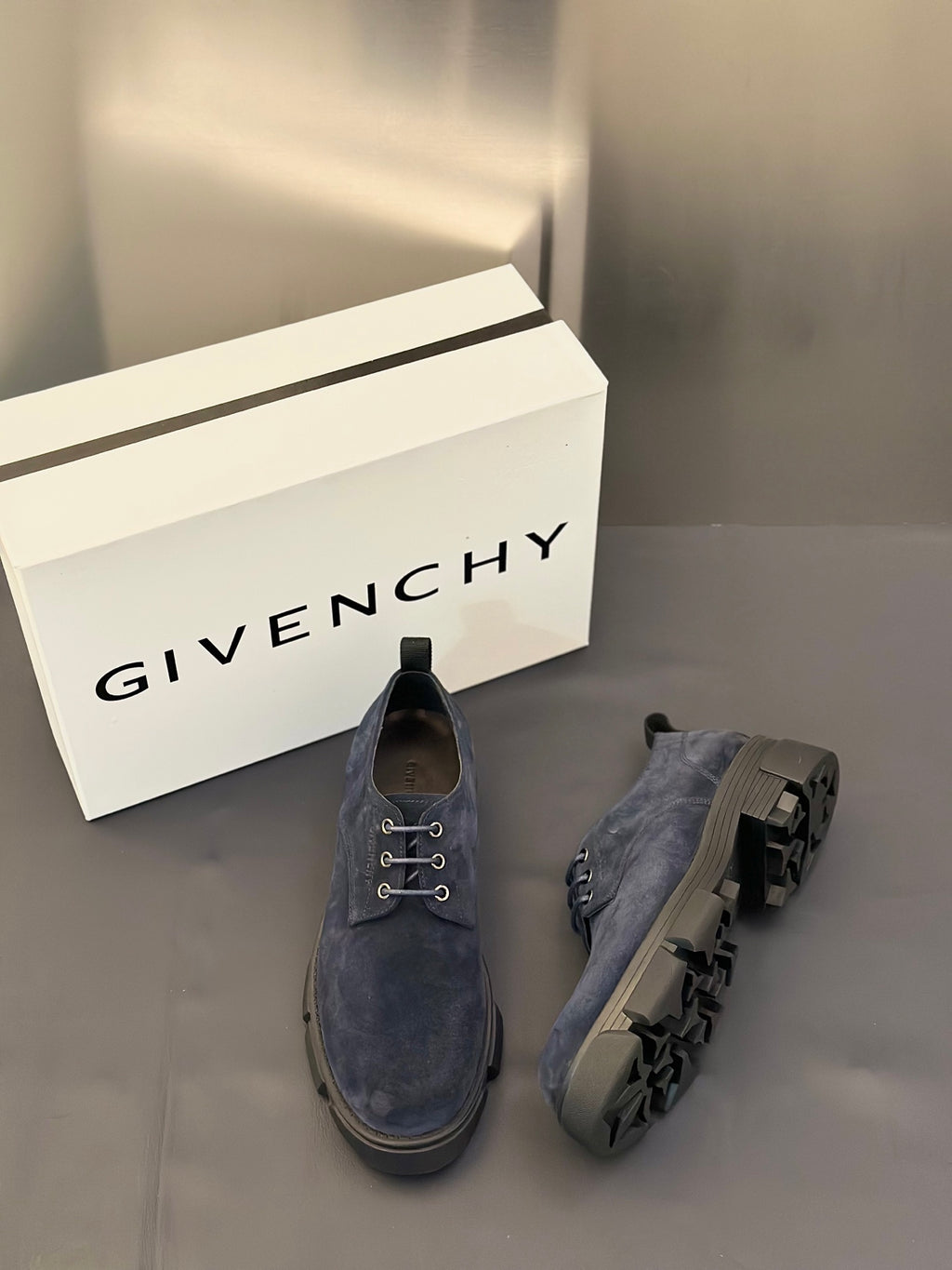 Navy suede lace-up shoes with lace front and stacked outsole heel
