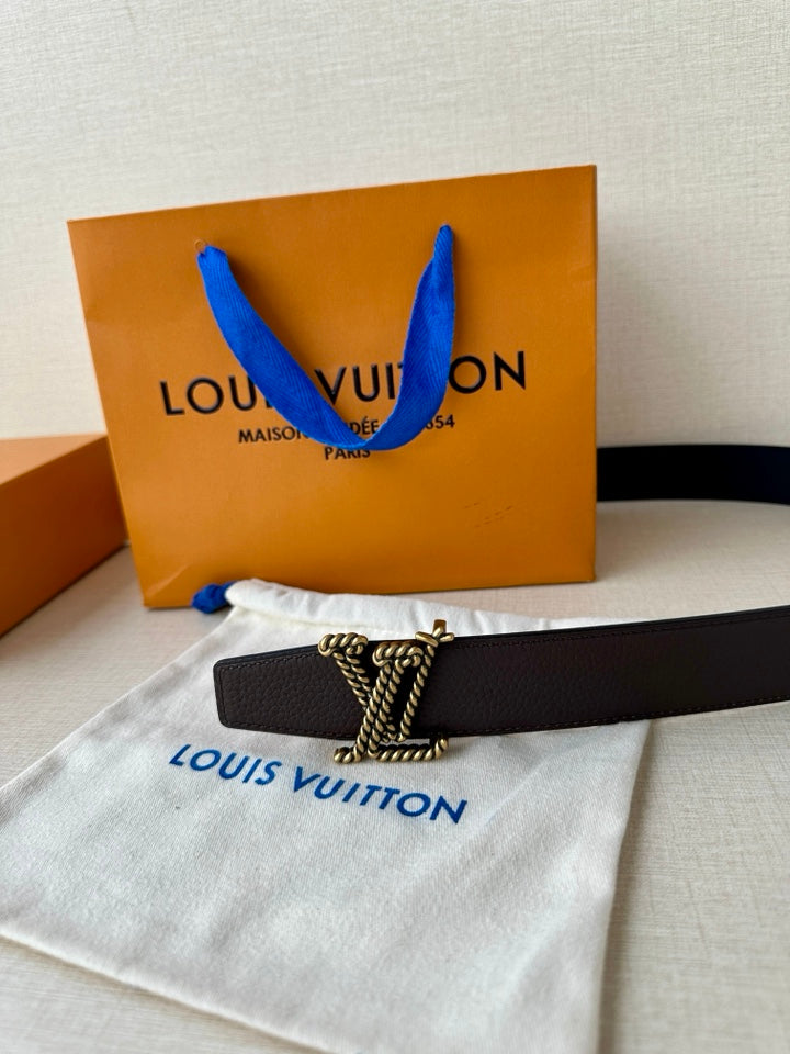 Louis Vuitton belt laid flat: dark leather band with gold-tone buckle and clasp