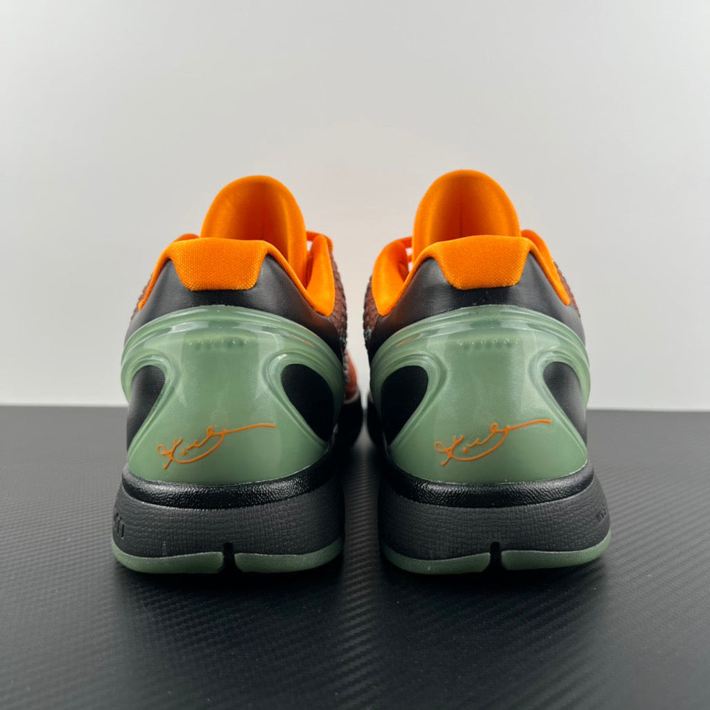 Back view of orange basketball shoes with green heel and black sole