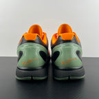 Back view of orange basketball shoes with green heel and black sole