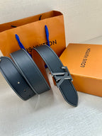 Louis Vuitton belt with dark blue strap and silver LV buckle shown in a side view