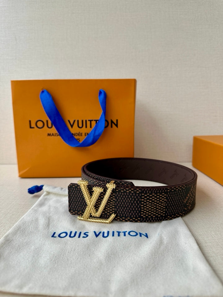 Dark monogram belt with gold rhinestone buckle centered on the strap.