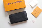 Textured leather zip wallet in dark tone with Louis Vuitton logo and key ring