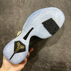 Basketball sneaker outsole in white with black traction and gold heel emblem