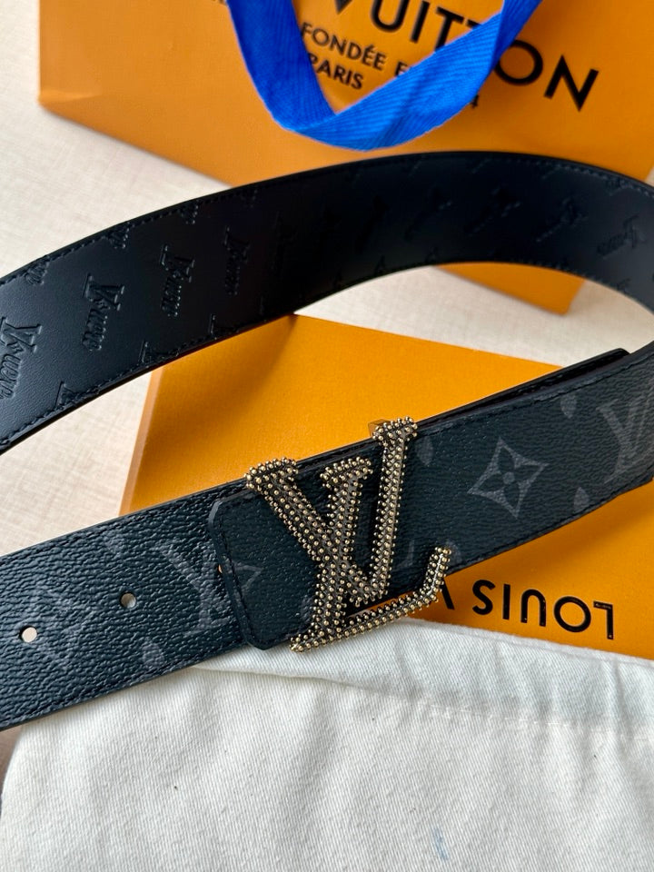 Close-up Louis Vuitton belt with dark blue monogram strap and rhinestone LV buckle