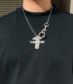 Balenciaga dog-tag necklace with chain and metal rings on dark crewneck shirt