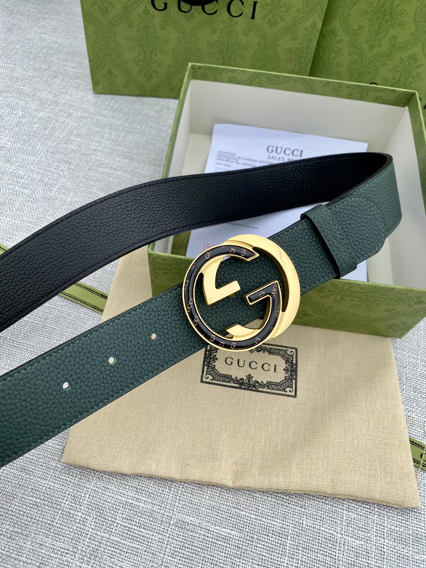 Gucci belt dark green leather with round GG logo buckle and perforated holes