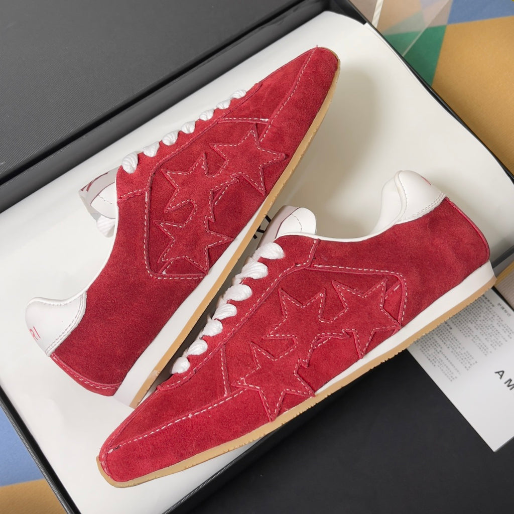 Red suede Amiri sneakers with star-embossed detail, gum-style rubber sole