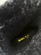 Louis Vuitton logo on black fur-lined insole